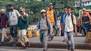Workers pass by Tata Steel Ltd. plant in Jamshedpur, highlighting daily operations at one of the company’s key production sites. Tata Steel India reported a 7% year-on-year rise in crude steel production in Q2 FY26 following furnace relining at its Jamshe