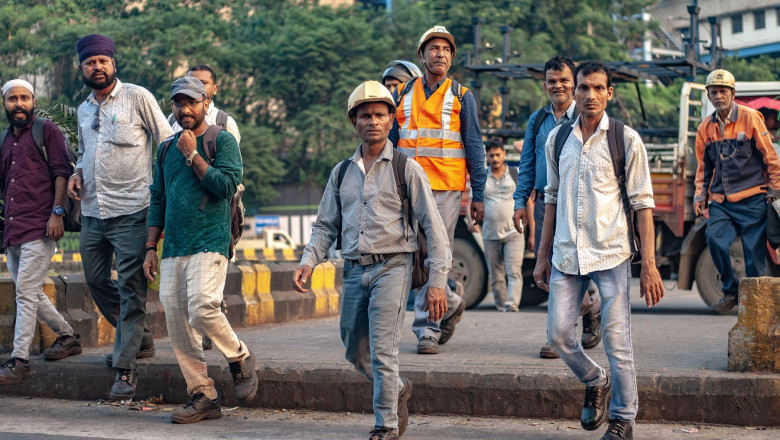 Workers pass by Tata Steel Ltd. plant in Jamshedpur, highlighting daily operations at one of the company’s key production sites. Tata Steel India reported a 7% year-on-year rise in crude steel production in Q2 FY26 following furnace relining at its Jamshe