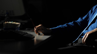 Man at his desk in the dark