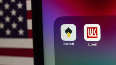 Quito, ECUADOR - Oct 27 2025 : Rosneft and Lukoil icons displayed on a screen with the U.S. flag in the background.