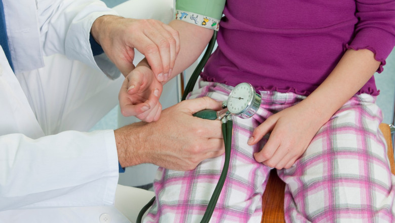 Doctor testing childs blood pressure