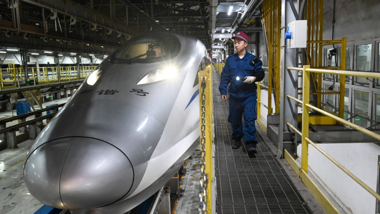 KUNMING, CHINA - JANUARY 13: Maintenance worker checks a bullet train ahead of the Spring Festival travel rush on Januar