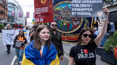 People holding placards which read Free Ukrainian children kidnapped by Russia at the March for the children of Ukraine at the March for the children of Ukraine on 1st June 2025 in London, United Kingdom. This demonstration was organised by Ukraine Solida