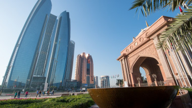 Emirates Palace Abu Dhabi; Dubai; United Arab Emirates - Stone archway with skyscraper in Abu Dhabi