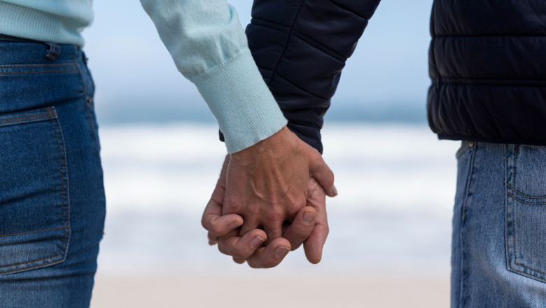 Couple standing with holding hands on the beach