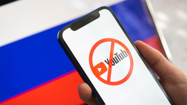 Poltava, Ukraine - March 23, 2022: Youtube and Russia flag. Sanctions, ban and banned business. Youtube logo, big company stopped working in Russian F