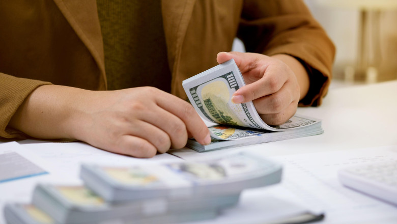 Businessman analyzing investment charts and pressing calculator buttons over documents. Accounting Concept