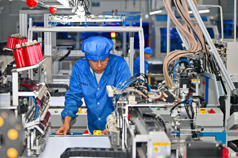 GANZHOU, CHINA - OCTOBER 28: An employee works on the production line of chip card products at a digital workshop of She