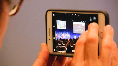 A delegate take a photo with her phone as the President of Ukraine, Volodymyr Zelenskyy's speaks at the NATO Parliamentary Assembly. The NATO Parliamentary Assembly (NPA) is an inter-parliamentary organization for parliamentarians in NATO’s Member States