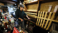 An employee cleans up at an "izakaya" pub in Hachinohe, Aomori Prefecture, on Tuesday, Dec. 9, 2025, in the wake of a huge earthquake that rocked northeastern Japan the night before
