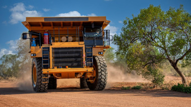 mining truck in a diamond mine, driving on dirt road gravel, brand new delivery