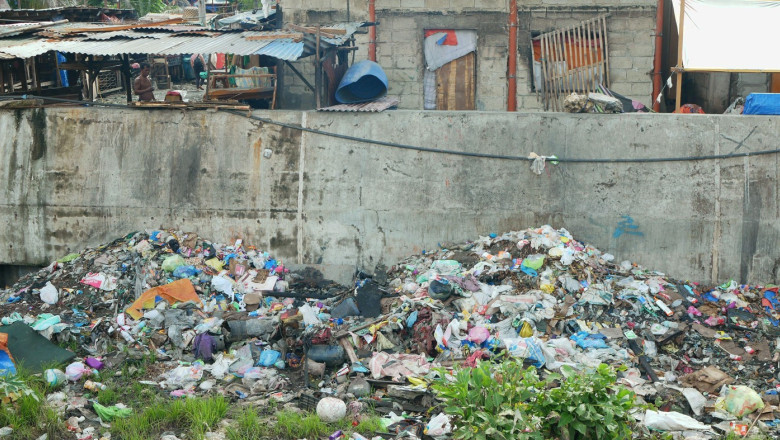 MANDAUE CITY, PHILIPPINES, JUNE 15, 2025: Plastics garbage Philippine slum poor river waste shanty landfill waste pollution Tipolo Creek fecal