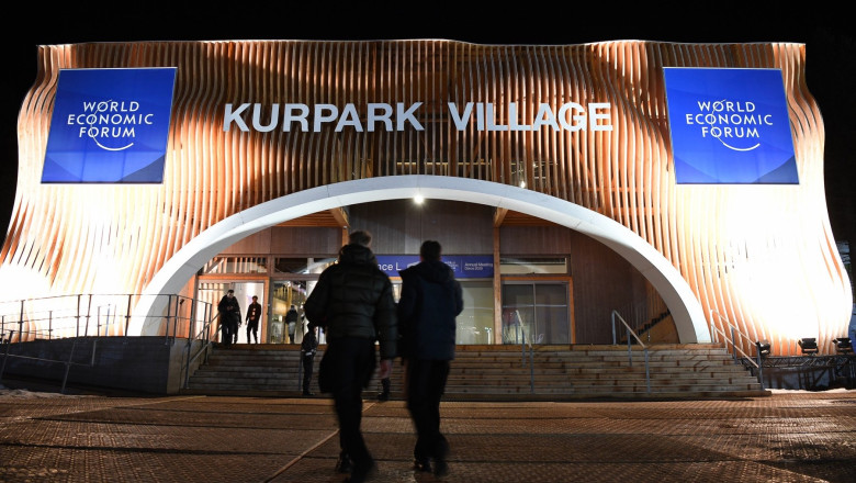 Participants walk into Davos Kurpark Village prior to the opening of the annual meeting of the World Economic Forum in Davos, Switzerland