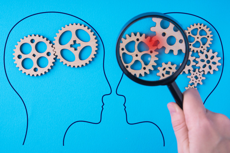 Human brain is made gear mechanism. The brain is viewed through a magnifying glass. Brain damage concept.