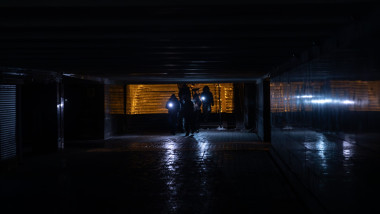 Pedestrians are seen navigating a darkened underground passage in Kyiv, Ukraine, during a power outage