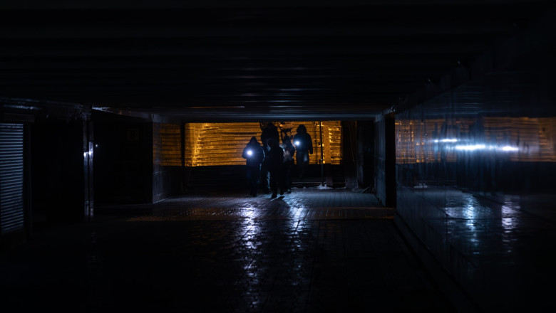 Pedestrians are seen navigating a darkened underground passage in Kyiv, Ukraine, during a power outage