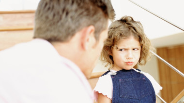 Father telling off naughty daughter