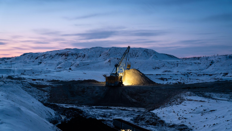 Coal mining at an open pit. Coal mine in winter covered with snow. Russia