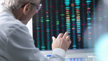 DNA Research, Scientist comparing DNA results on a computer screen in the laboratory
