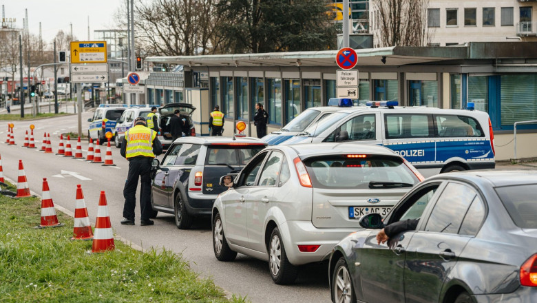 Kehl, Germany - Mar 16, 2020: Polizei officer checks Mini cooper car traffic at the border crossing in Kehl from France Strasbourg during crisis measures in fight against the novel coronavirus