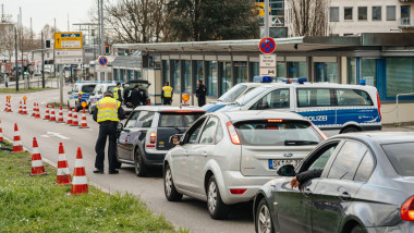 Kehl, Germany - Mar 16, 2020: Polizei officer checks Mini cooper car traffic at the border crossing in Kehl from France Strasbourg during crisis measures in fight against the novel coronavirus