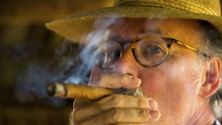 Tourist smokes a Havana cigar, Tobacco farm in the Vinalestal, Viñales, Cuba