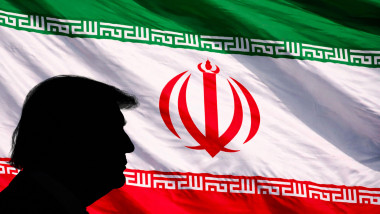 Silhouette profile of former U.S. President Donald Trump positioned on the left against a full-frame, waving Iranian flag, representing geopolitics, i
