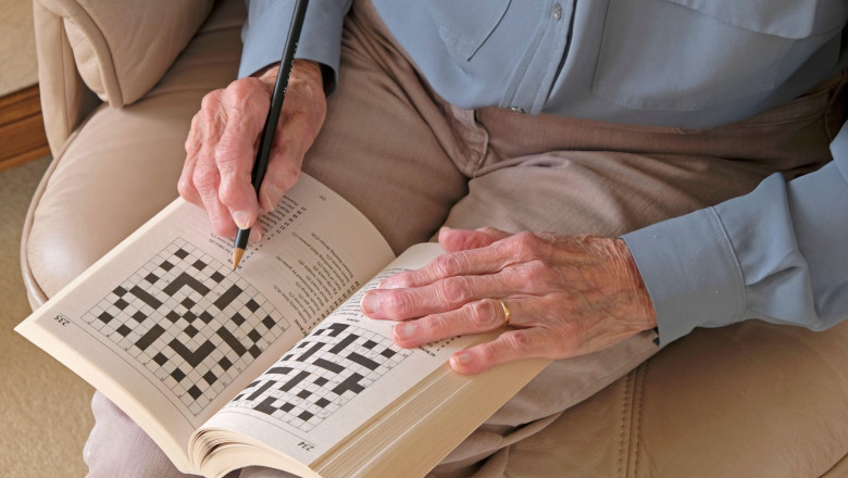 Hands of a Senior lady doing a crossword puzzle