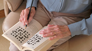 Hands of a Senior lady doing a crossword puzzle