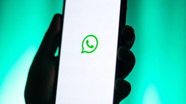 Kaliningrad, Russia - 12.11.2025. Smartphone screen in woman hands displaying logotype of popular messenger WhatsApp. Meta corporation