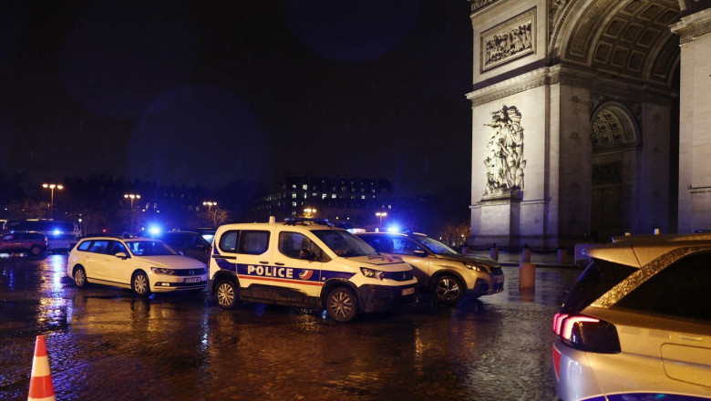 Police cars block the area around the Arc de Triomphe in Paris on February 13, 2026, after police shot a knife-wielding man