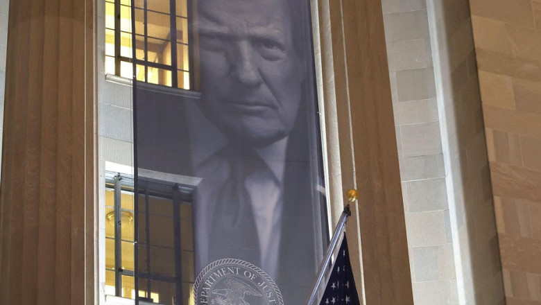 Washington, DC, USA. 19th Feb, 2026. A large banner featuring Donald Trump's face seen hung on the exterior of Justice Department headquarters in Washington, DC on February 19, 2026. Credit: Mpi34/Media Punch/Alamy Live News