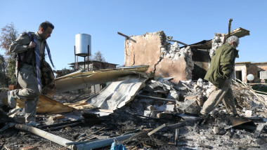 two Iranian Kurdish Peshmerga member of the Kurdistan Democratic Party of Iran (KDPI) inspect damage sustained at the Azadi Camp of the Kurdistan Democratic Party of Iran (KDPI)