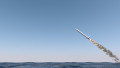 An intercontinental ballistic missile launching across the ocean on a blue sky backgrund - 3D render