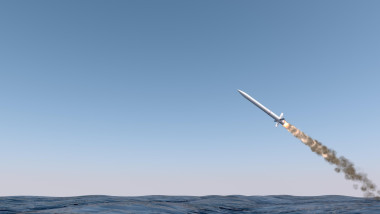 An intercontinental ballistic missile launching across the ocean on a blue sky backgrund - 3D render