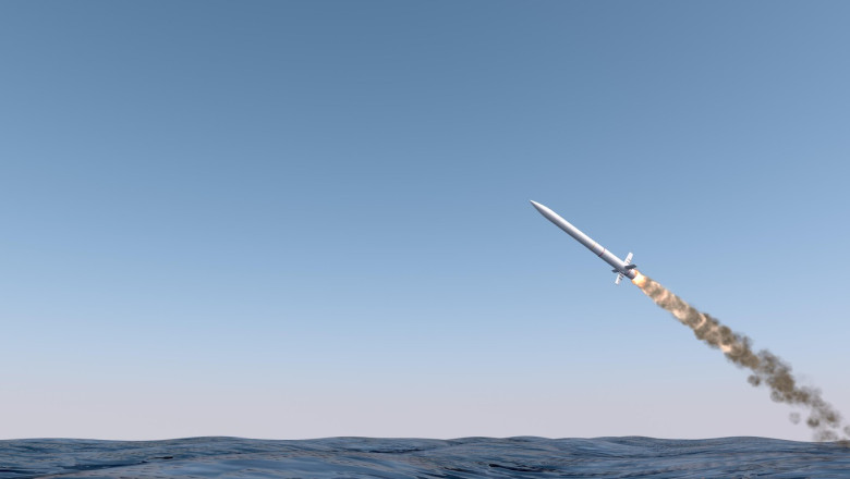 An intercontinental ballistic missile launching across the ocean on a blue sky backgrund - 3D render