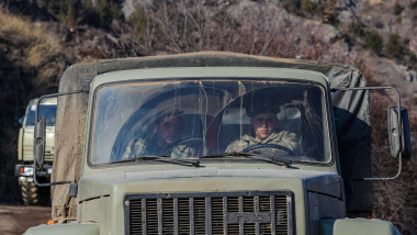 Trucks of Azerbaijan army, accompanied by Russian peacekeeping troops drive along the Lachin corridor on Tuesday, Dec 22