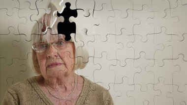 Jigsaw puzzle, of a senior woman, falling apart