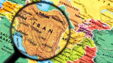 Iran highlighted on political map under magnifying glass