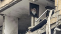 A portrait of Iran’s late Supreme Leader Ayatollah Ali Khamenei, killed in the opening salvo of a US and Israeli attack on Iran on February 28, is seen hanging on the wall of a destroyed building, the site of an Israeli airstrike in Beirut’s southern suburb of Haret Hr