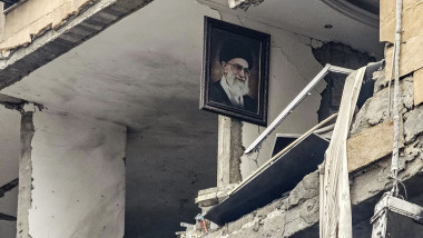 A portrait of Iran’s late Supreme Leader Ayatollah Ali Khamenei, killed in the opening salvo of a US and Israeli attack on Iran on February 28, is seen hanging on the wall of a destroyed building, the site of an Israeli airstrike in Beirut’s southern suburb of Haret Hr