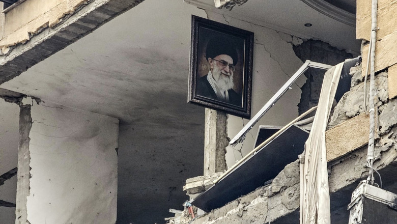 A portrait of Iran’s late Supreme Leader Ayatollah Ali Khamenei, killed in the opening salvo of a US and Israeli attack on Iran on February 28, is seen hanging on the wall of a destroyed building, the site of an Israeli airstrike in Beirut’s southern suburb of Haret Hr