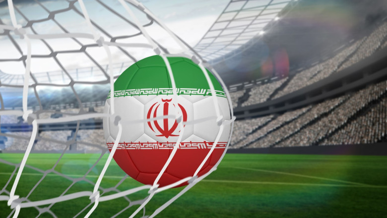 Football in iran colours at back of net