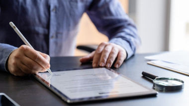 Man Signing The Digital Contract
