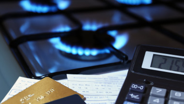 bank cards and a calculator on the background of a gas stove