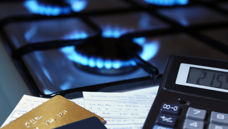 bank cards and a calculator on the background of a gas stove