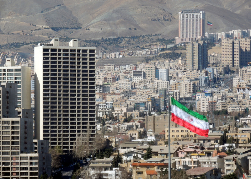 Tehran urban skyline and Iran flag