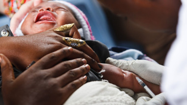 An infant receives BCG vaccine during a routine vaccination session at the Kasambondo health center in Kasambondo, DRC