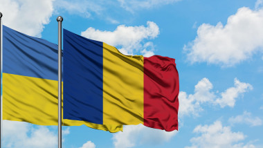 Ukraine and Romania flag waving in the wind against white cloudy blue sky together. Diplomacy concept, international relations.