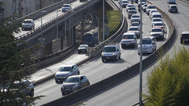 Traffic congestion on a highway viaduct in Nice, France. Includes cars, vans, and a passing SNCF train underneath.